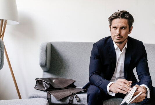 Businessman with notebook sitting on couch