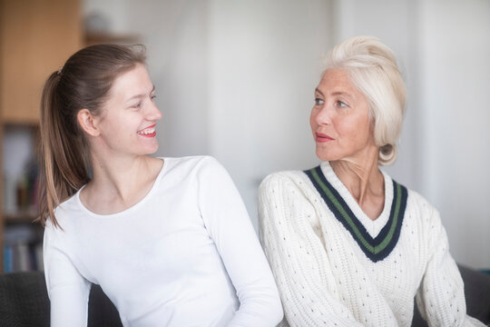Mature woman and adult daughter looking at each other