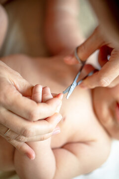 Safe rounded scissors used for trimming fingernails of newborn baby to prevent injury