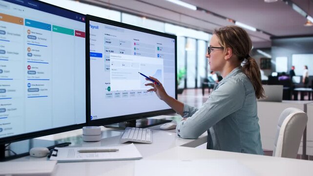 HR Manager Carefully Reviews Payroll Software