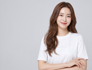 Fototapeta premium A beautiful young Asian woman in a white shirt smiling warmly