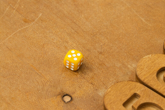 Yellow Dice Rolled on Wooden Shut the Box Board Game