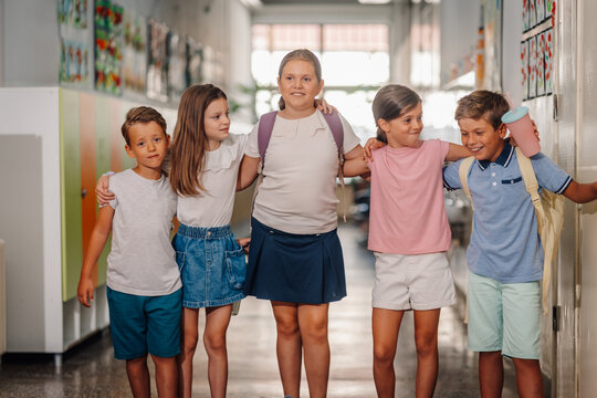 Group of children walking together in school hallway