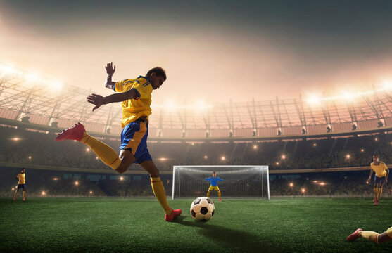 Football player shooting the ball at the goal.