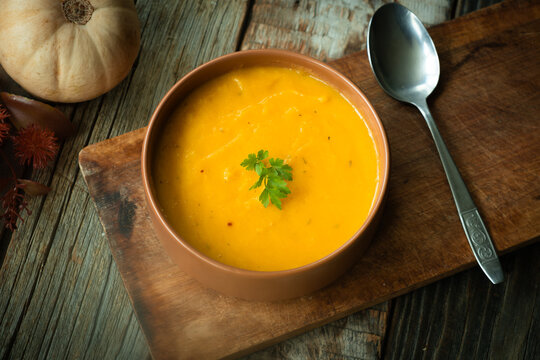 Bowl of pumpkin soup. Tradition autumn food, vegetable cream soup. Thanksgiving dinner