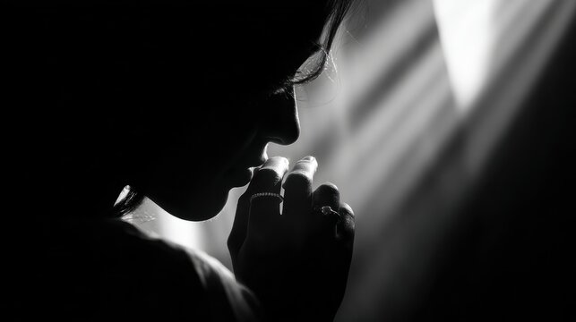 Praying hands silhouette in soft light