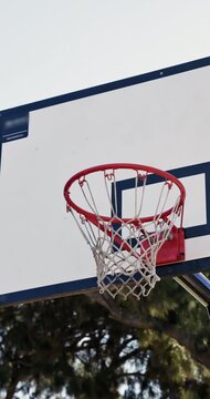 Sports, empty and net for basketball, match and game with hoop for score or goal outdoor. Park, court and equipment for competition, tournament and background for fitness, active hobby and practice