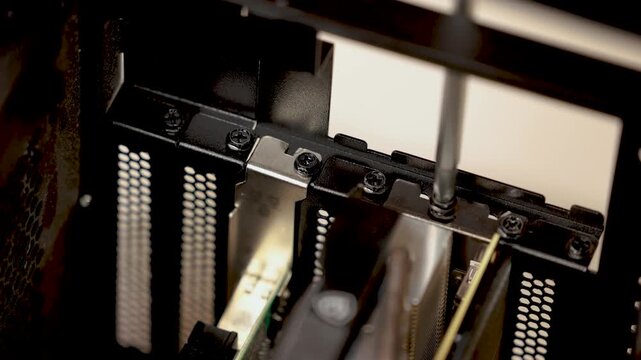 A close-up of graphics cards or expansion cards being removed or viewed outside of a desktop computer case.