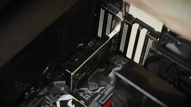A close-up of the upper portion of a desktop computer case interior showing hardware components and cooling systems in dark lighting.