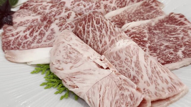 Close-up of premium A5 Wagyu beef slices arranged on a serving plate, highlighting exceptional marbling and elegant presentation for gourmet dining.