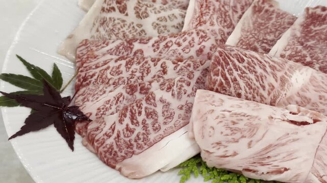 Close-up of premium A5 Wagyu beef slices arranged on a serving plate, highlighting exceptional marbling and elegant presentation for gourmet dining.