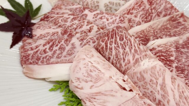 Close-up of premium A5 Wagyu beef slices arranged on a serving plate, highlighting exceptional marbling and elegant presentation for gourmet dining.