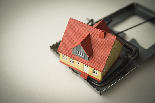 House in a rat trap on white background copy space. Real estate, property, land, rental, mortgage closing scams concept. Protect money from real estate scams when buying, rental a home.