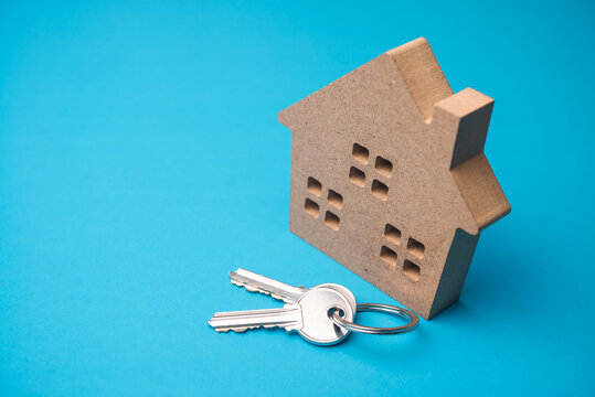 House with house key on blue background with copy space. Homebuyer financial planning for dream home, mortgage loan, banking, home improvement, construction industry and so on concept.