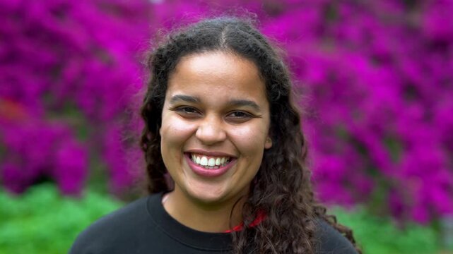 Happy african girl smiling on camera after yoga class outdoor - Curvy young multiracial woman, healthy lifestyle and sport concept