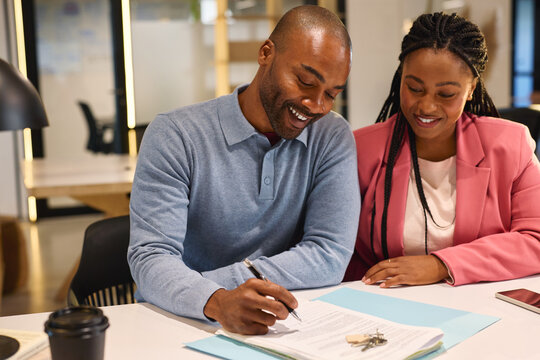 Black couple signing a legal real estate contract