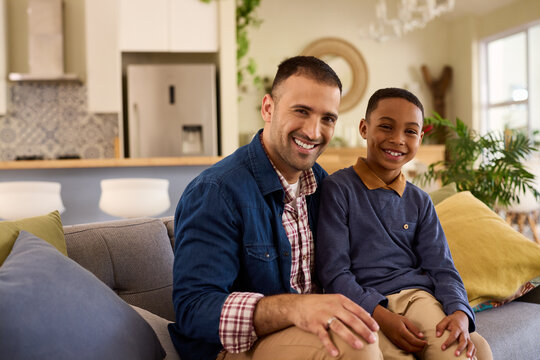 Portrait of multiethnic happy father with son looking at camera