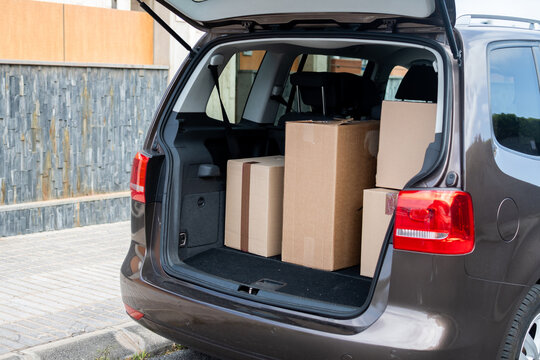 Car trunk packed with moving boxes