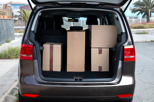 Car trunk packed with moving boxes