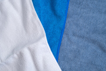 Fototapeta premium Blue, grey and white microfiber towels for cleaning and home textile concept 