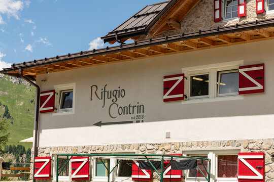 11 July 2026, Canazei, Italy. Rifugio Contrin mountain refuge facade in the Dolomites with traditional alpine architecture