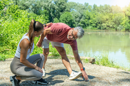 Senior participant practicing a standing flexibility exercise under professional supervision to increase joint mobility, muscle elasticity 