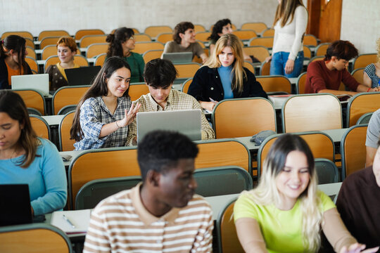 Students inside university class room using laptop - Back to school and campus lifestyle concept - Main focus on center girl face - UGC content