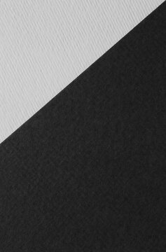 black and white backdrop with different textures: close up of two sheets of craft paper