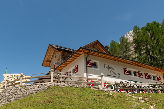 11 July 2026, Canazei, Italy. Rifugio Contrin alpine mountain refuge with parked mountain bikes in the Dolomites