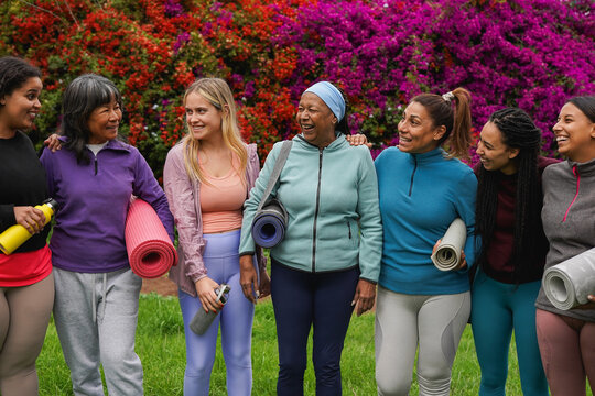 Happy multiracial women with different age and body having fun together after yoga class - Multi generational female group, healthy lifestyle and retreat concept