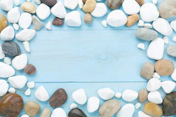 White pebble stones on wooden background, top view © Liami