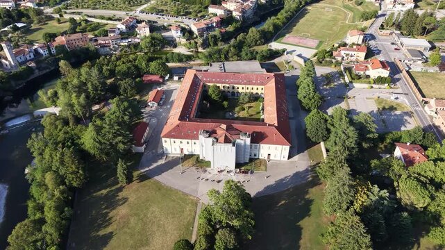 Aerial view of historic Italian building with inner courtyard and red tile roof