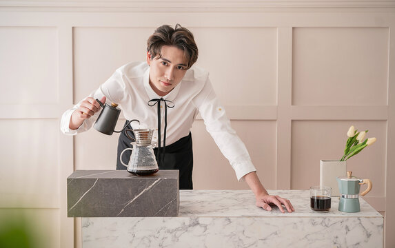 Startup successful small business owner sme handsome asian man drip hot water in to filter paper coffee slow bar in cafe. Portrait young man barista cafe owner SME entrepreneur