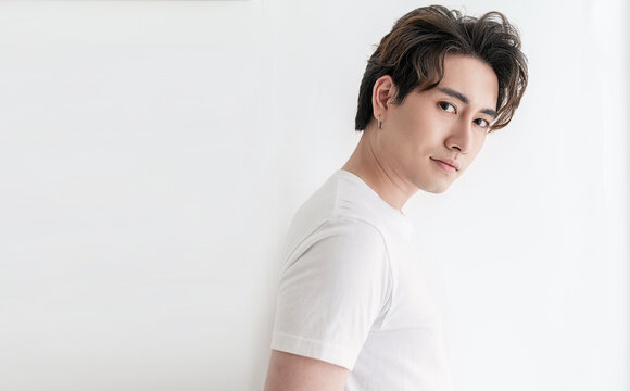 Attractive young handsome smiling face positive asian, korean happy casual man, stay home minimal lifestyle. Closeup portrait of asia middle age 20s man wearing white shirt in studio. Young model boy