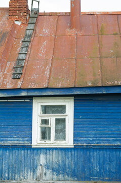 Rustic wooden house features vintage window