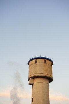 Industrial tower rises beneath blue sky