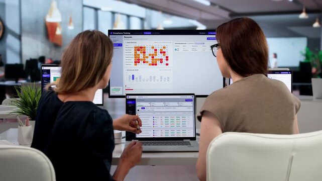 Young Woman Reviews Employee Training Progress On Laptop