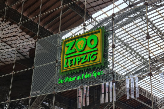 Leipzig, Germany, May 4, 2026: Zoo Leipzig Entrance Sign with Green Nature Theme Reflecting on Glass in Modern Architecture