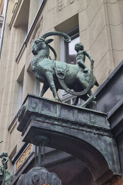 Leipzig, Germany, May 3, 2026: Historic Bronze Goat Statue with Mythical Child Rider in Urban Setting