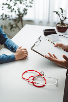 Doctor discussing medical history with patient during consultation, explaining treatment options and providing professional healthcare advice in clinic