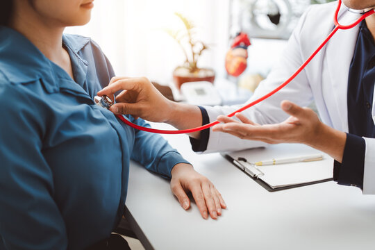 Doctor examining a patient's heart using a stethoscope, performing a health check-up and consulting about cardiovascular disease prevention