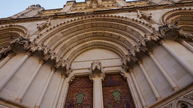 Low angle architectural detail of pointed arches above the main doors of Cuenca Cathedral