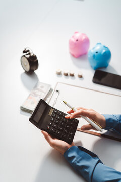 Person calculating finances, managing budget, saving money, planning investments, and making financial decisions for future wealth and security