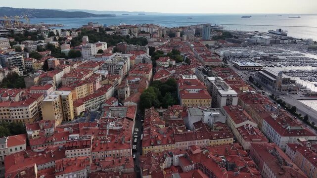 Drone shot of red tile rooftops in Trieste old town center, Italy