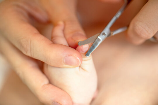 Newborn baby hygiene routine including gentle nail trimming by mother