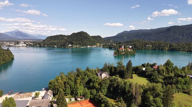 Flight over Lake Bled Island Church with Julian Alps in background, Slovenia