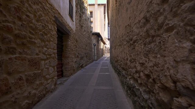 Narrow medieval stone alley leading through the historic old town of Cuenca Spain