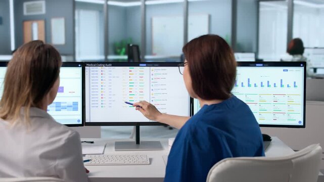 Woman In Healthcare Uniform Uses Computer