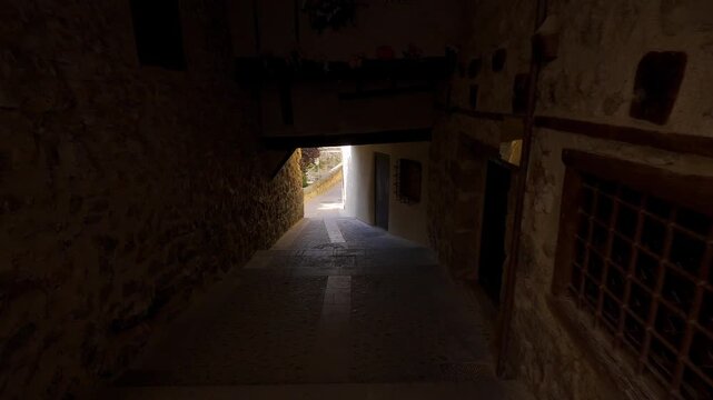 Ancient arched tunnel passage in a quiet medieval street of Cuenca old town Spain