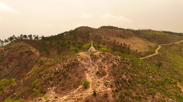 Drone orbit around the Way of the Cross summit on Michiru Mountain, revealing the pilgrimage trail, surrounding hills, planted forests and the mountain landscape near Blantyre, Malawi.